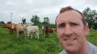 Aonghusa Fahy with his cattle in backgrond